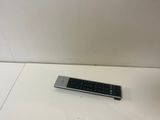 a remote control sitting on a table next to a wall