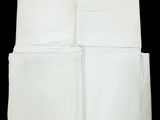four white napkins are stacked on top of each other on a black background