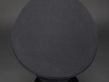 a black hat sitting on top of a black table