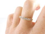 a woman ' s hand with a diamond ring on it