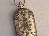 an antique silver locke with a chain hanging from it ' s side