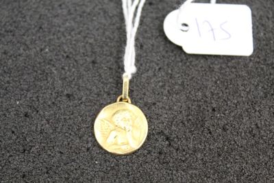 a close up of a gold coin on a string with a price tag