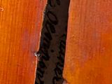 a close up of a guitar that has a piece of writing on it
