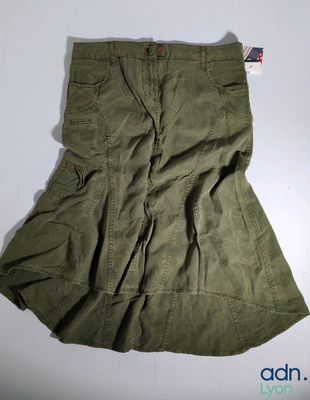 the skirt is green and has buttons on the side