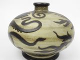a black and white vase with a design on it