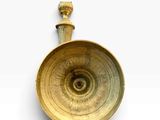 an antique brass candle holder on a white background