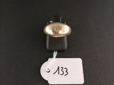 a close up of a bell on a black surface with a price tag