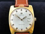 une photo d'une montre-bracelet en or avec un bracelet en cuir marron