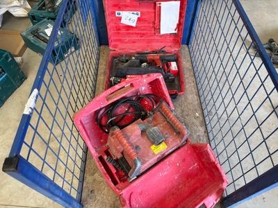 a red box with tools inside of it on the floor