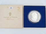 the coin is in a blue box with a white background