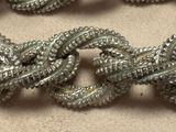 a close up of a chain of silver colored beads