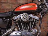 a close up of a motorcycle parked in front of a brick wall