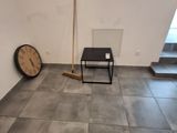 a room with a clock and a chair in it