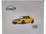 a yellow toy car in a white box on a white background