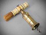 an old brass bell with a wooden handle and a wooden handle