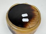 an image of a brown and black container with tags on it