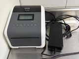 an image of a digital counter top with a printer and charger on it