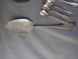 five spoons and two spoons sitting on a table