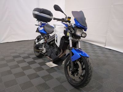 a blue and white motorcycle parked on a black and white checkered floor