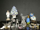 many glass figurines on display on a black table