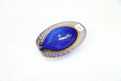 an image of a ring with a blue stone on a white surface