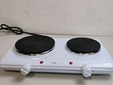 an image of a white electric stove top with two burners on it