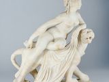 marble statue of a woman and a dog on a table