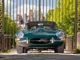 a green sports car parked in front of a gate