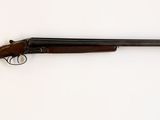 le fusil est posé contre le mur, à côté du mur