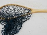 a close up of a fishing net on a white surface