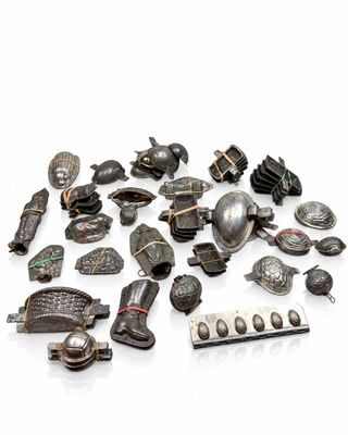 a pile of silver objects on a white surface