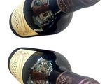 two bottles of wine that are sitting next to each other