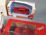 three boxes of toy cars sitting next to each other on a table
