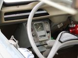a steering wheel and dashboard of a car with a clock on it
