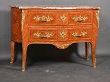 a small chest of drawers with a marble top