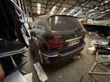 an image of a car in a garage with a lot of junk