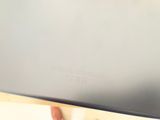 a person holding a laptop computer in their hand