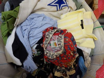 a pile of clothes in a basket on the floor