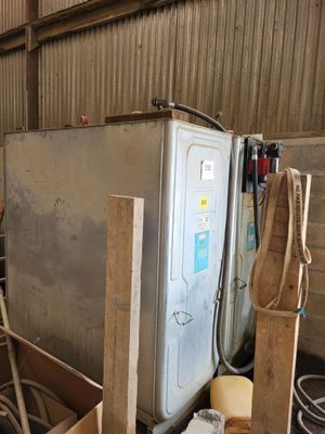 a man that is standing next to a refrigerator in a building
