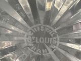 a close up of a clear glass plate with a logo on it