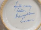 a person holding a cup with writing on it