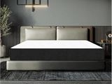 un lit avec un matelas posé dessus, dans une chambre