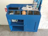a blue cabinet with a laptop on top of it