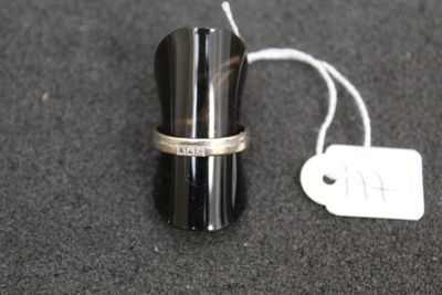 a silver ring on top of a black cup
