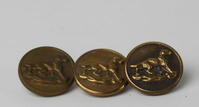 three antique brass buttons with a horse and rider on them