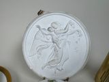 a white toilet with a picture of an angel on it