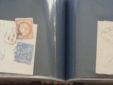 an open book with stamps on it sitting on top of a table