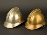 two helmets sitting next to each other on a black surface
