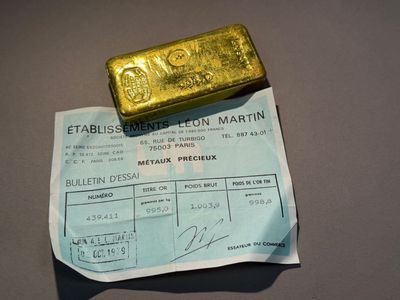 une pièce d'or posée sur une feuille de papier