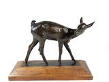 bronze sculpture of a deer on a wooden base on a white background